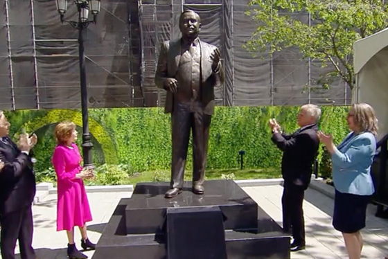 People clap as a statue of Jacques Parizeau is unveiled