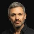 Headshot of Jason Hickel wearing a black shirt.