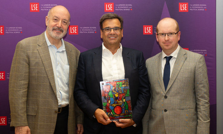 Jeremy Coller holding Fabian Window plaque with Larry Kramer on the left Professor Jonathan Birch on the right