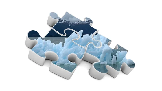 Three pieces of a jigsaw with an image of an iceberg on.