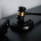 Judge’s gavel resting on a wooden sound block