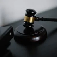 Judge’s gavel resting on a wooden sound block