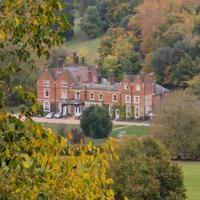 Juniper Hall surrounded by trees and countryside.