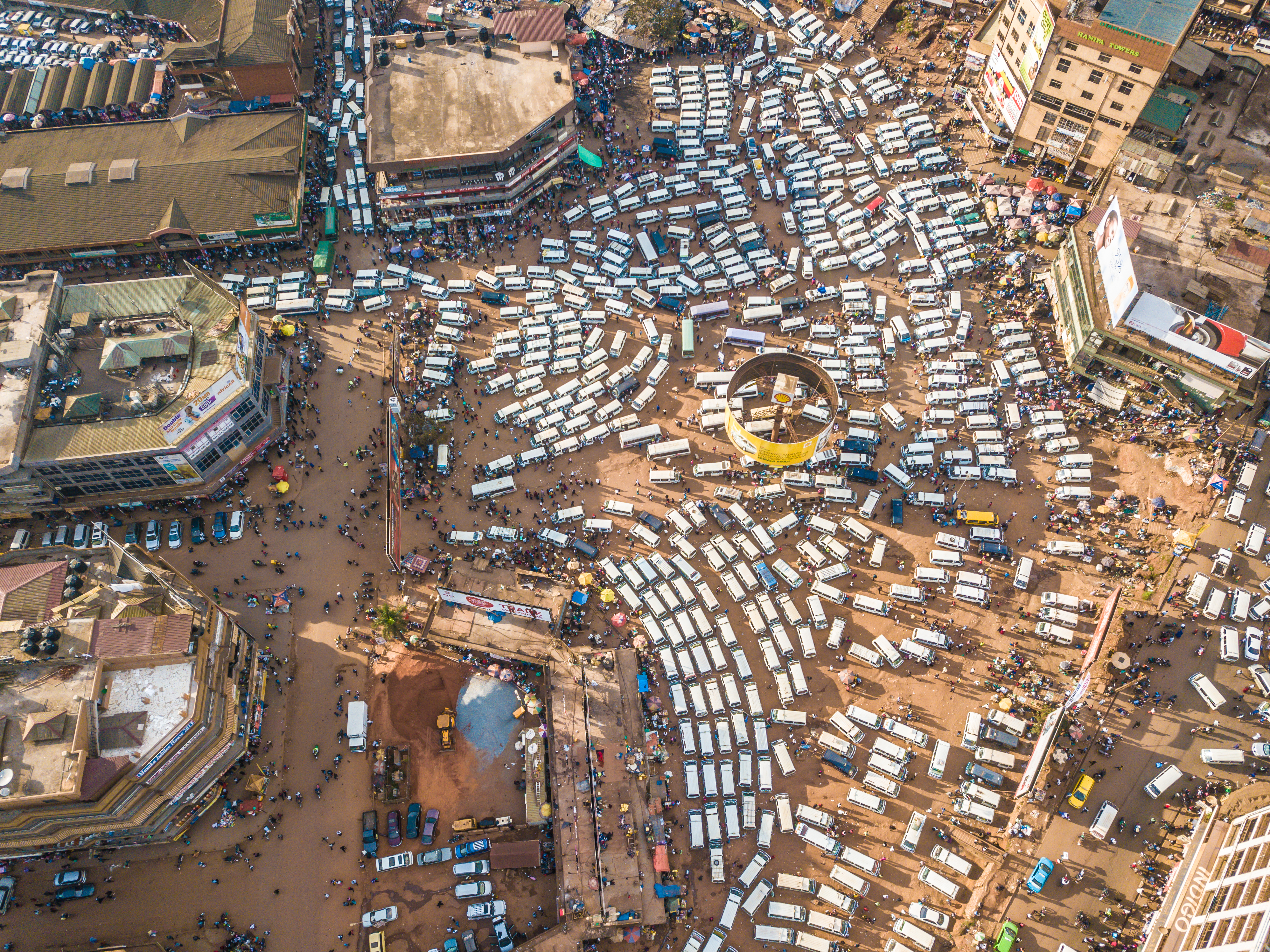 Overhead view of a many white taxis parked in Kampala