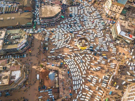 Overhead view of a many white taxis parked in Kampala