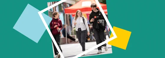Three students smiling and walking on campus
