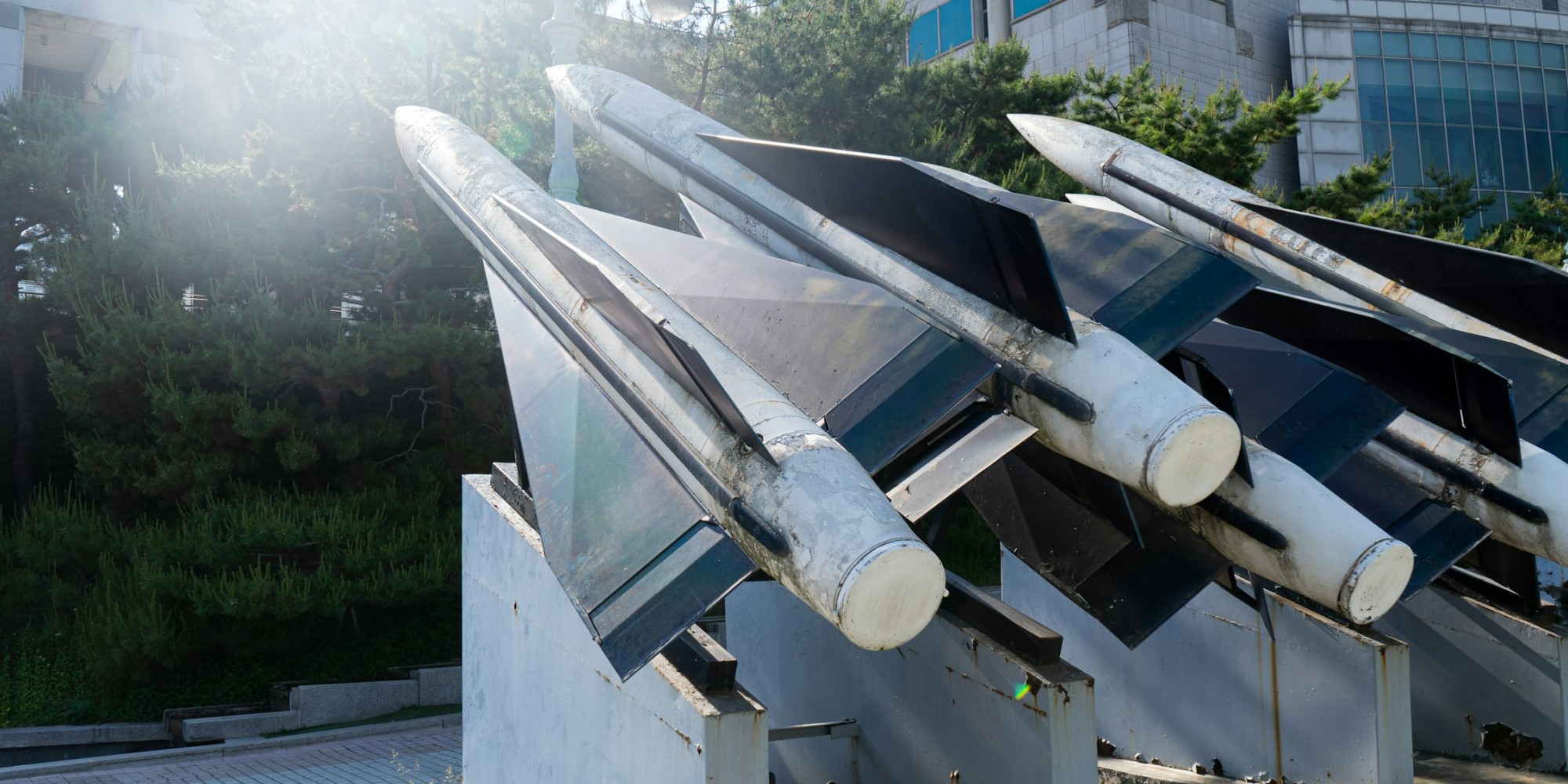 A static missile display in front of buildings