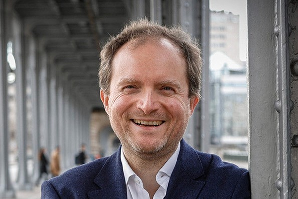 Portrait of Augustin Landier smiling into the camera