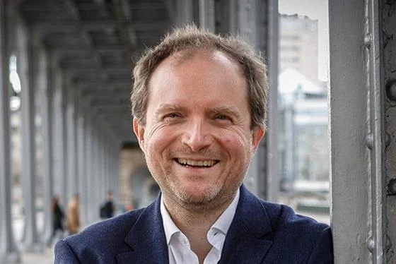 Portrait of Augustin Landier smiling into the camera