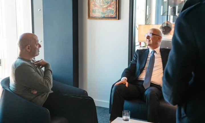 Professor Larry Kramer on the left talking to Minister Roland Lescure