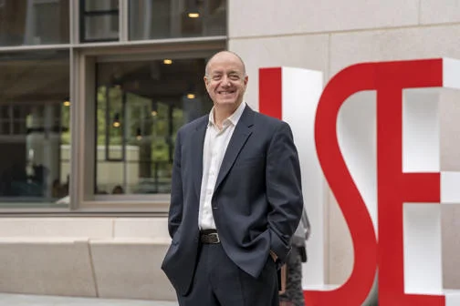 Larry Kramer, LSE President and Vice Chancellor, with the LSE letters