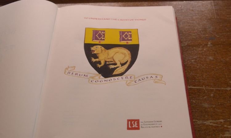 Page in the legacy book showing beaver and LSE motto to know the causes of things