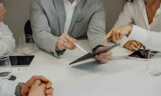 People looking at information on a tablet