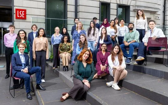 A large group of students on steps outside an LSE building