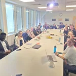 Researchers around a table meeting at LSE working on South Africa project