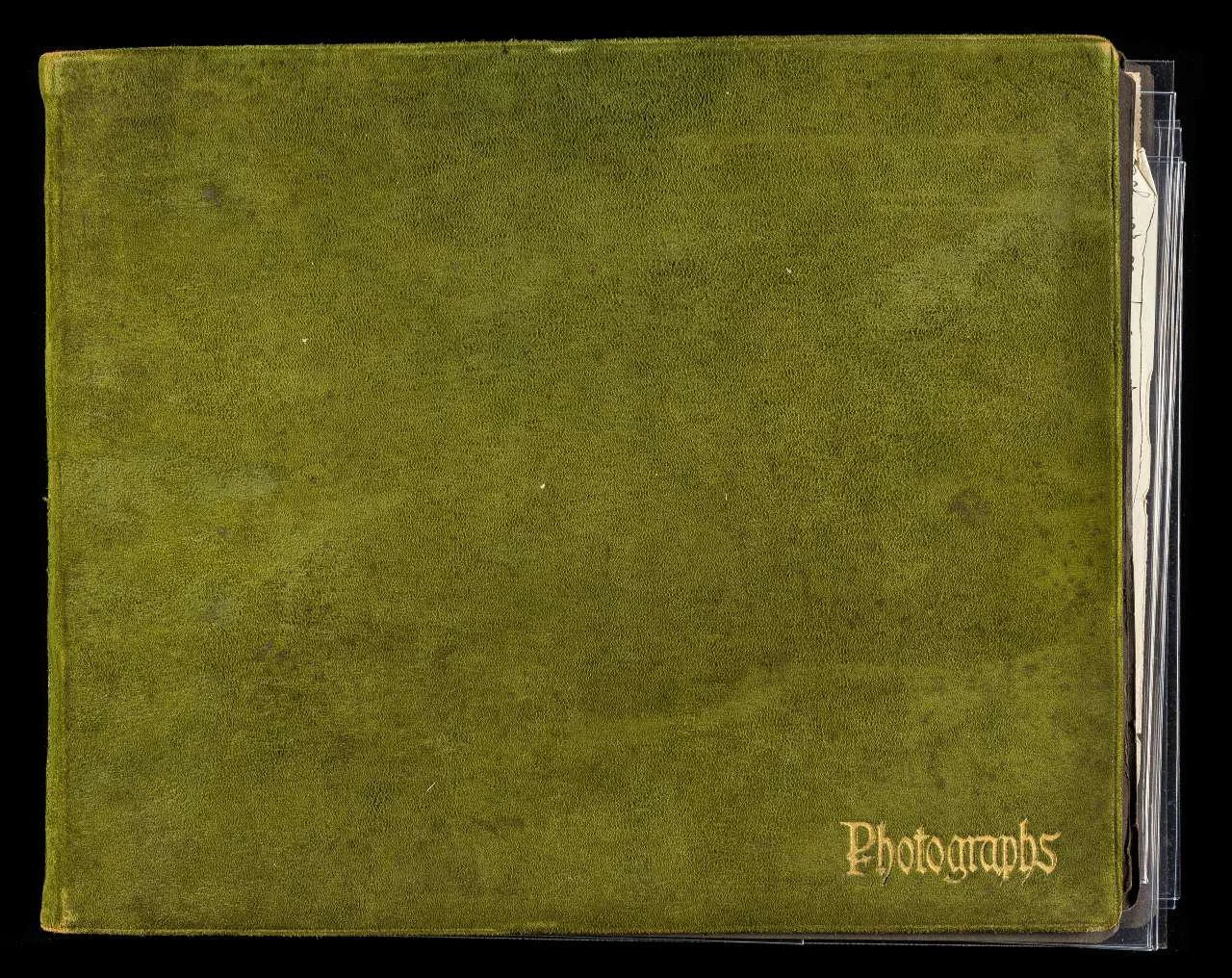 Green textured photo album with the word "Photographs" embossed in gold on the bottom right corner.