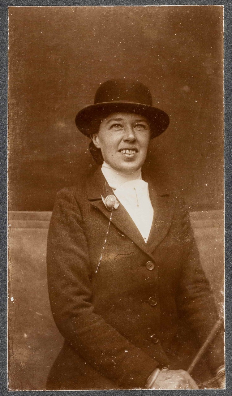 Vera 'Jack' Holme portrait. Smiling and wearing a bowler hat
