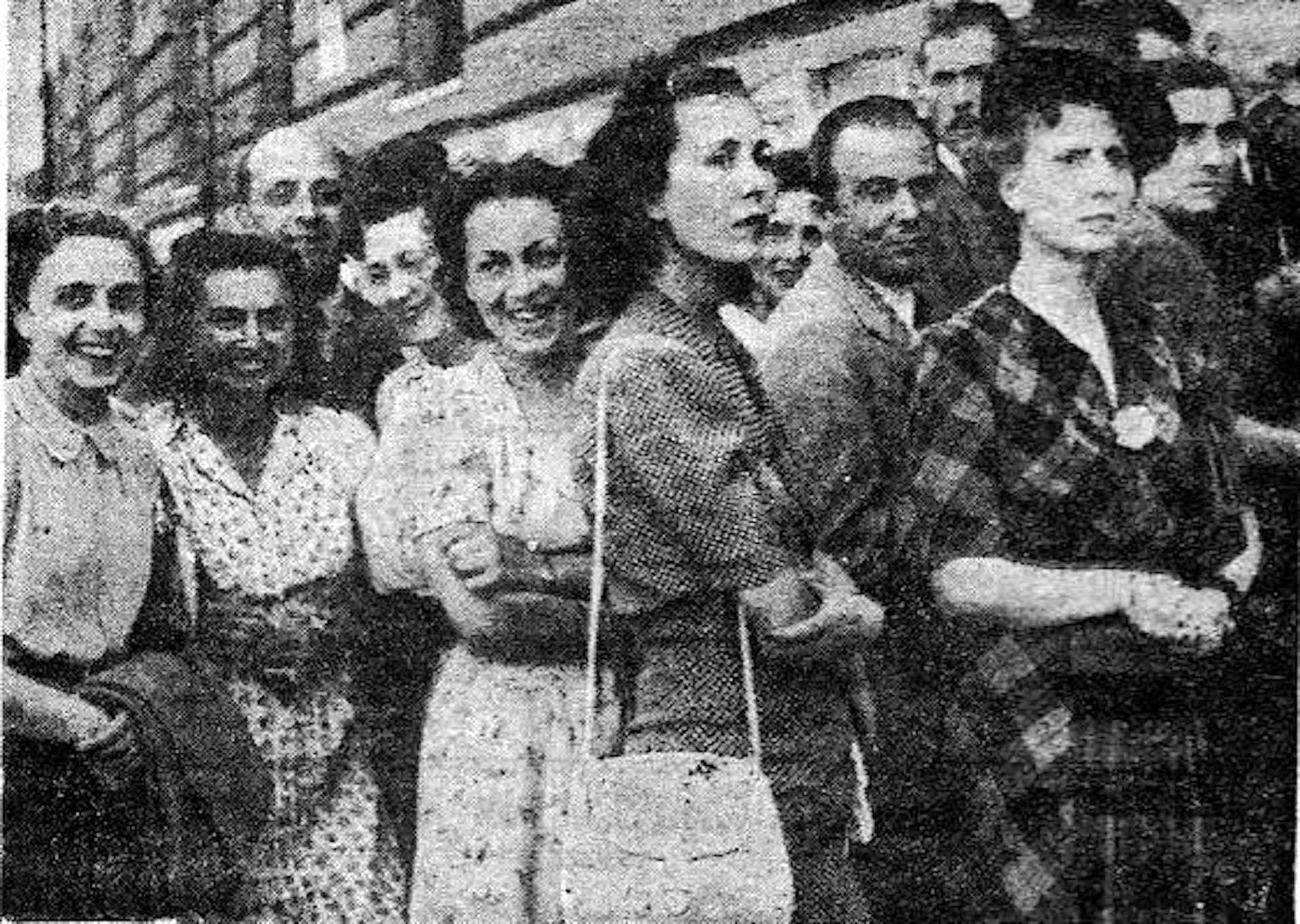 A group of expectant and smiling people.