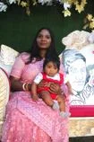 A woman and child sat on a sofa together.
