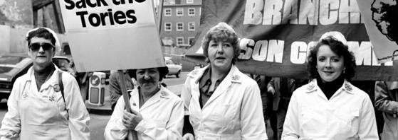 A group of protestors with placards and banners.