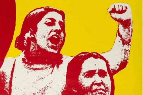 A yellow and red poster including women with raised fists and the words "So long as women are not free the people are not free"