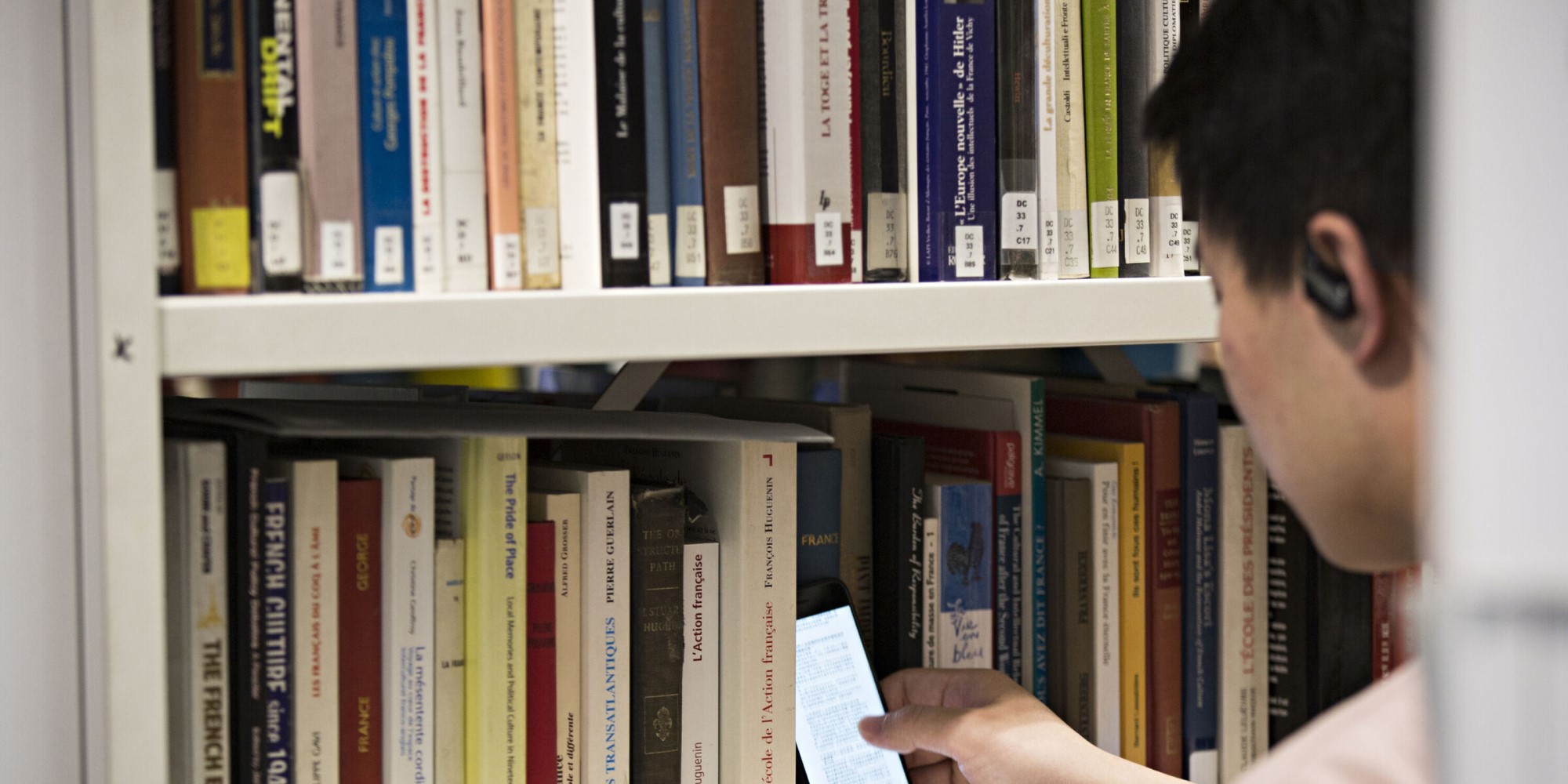 A student looking at books in a library