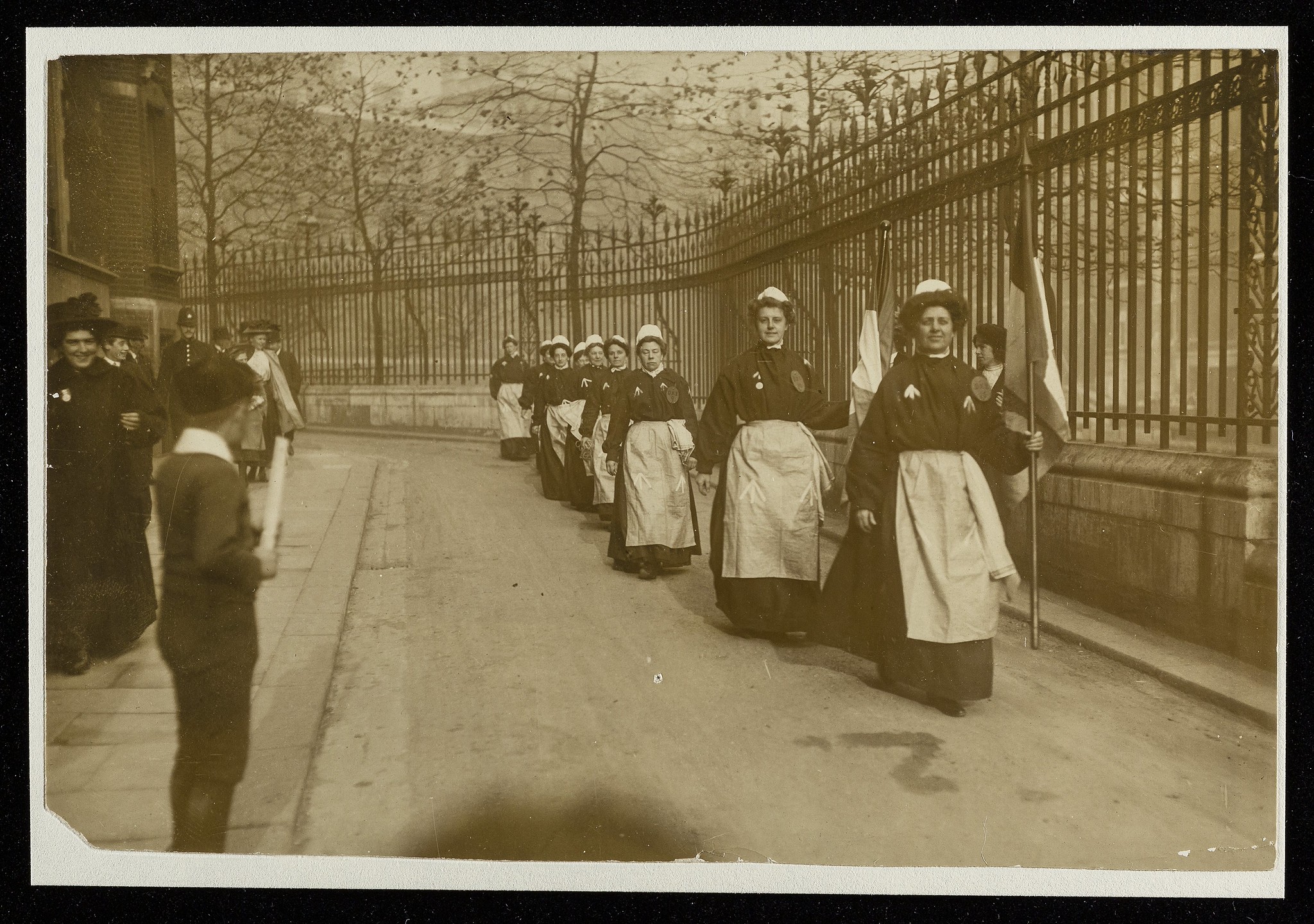Suffragettes in prison clothing marching along Clement's Inn, 1900s.