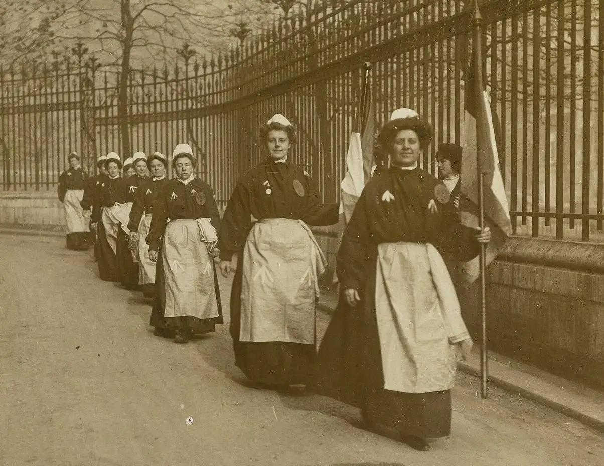 Suffragettes in prison clothing marching along Clement's Inn, 1900s.