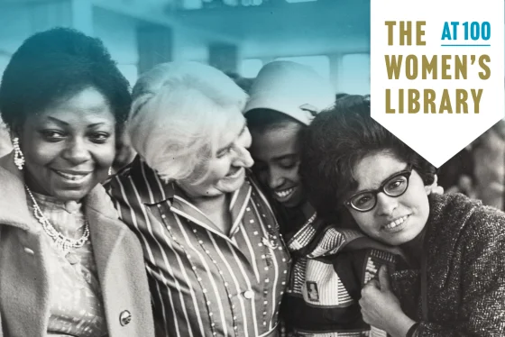 Four women smiling stood together
