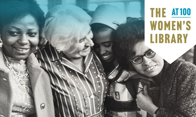 Four women smiling stood together