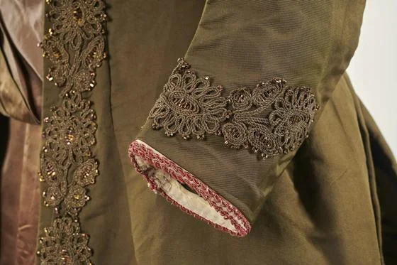 An intricate detail on the cuff of an outfit.