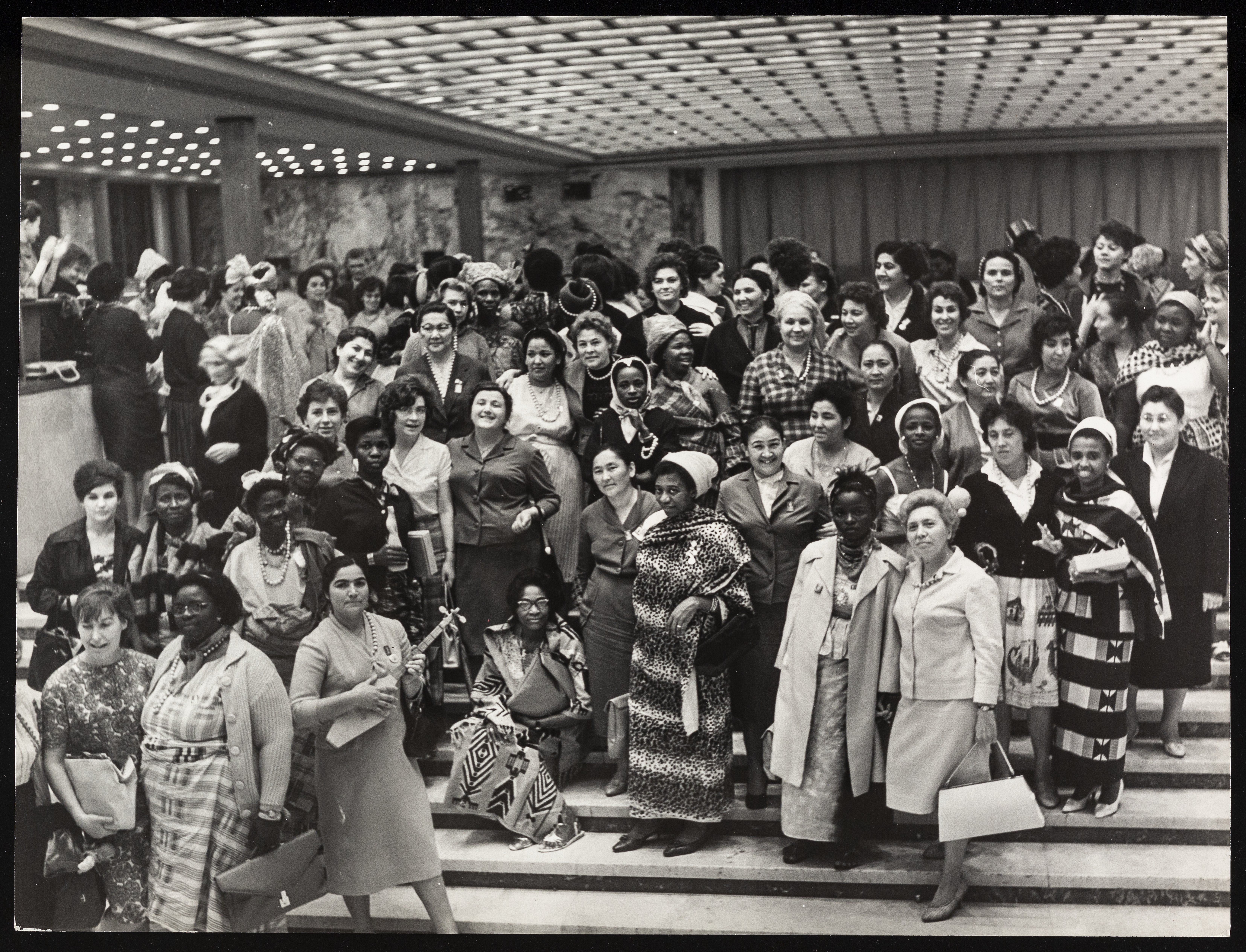 Delegates at the World Congress of Women, Moscow, Jun 1963, standing rows, on stairs in the lobby area of a building.