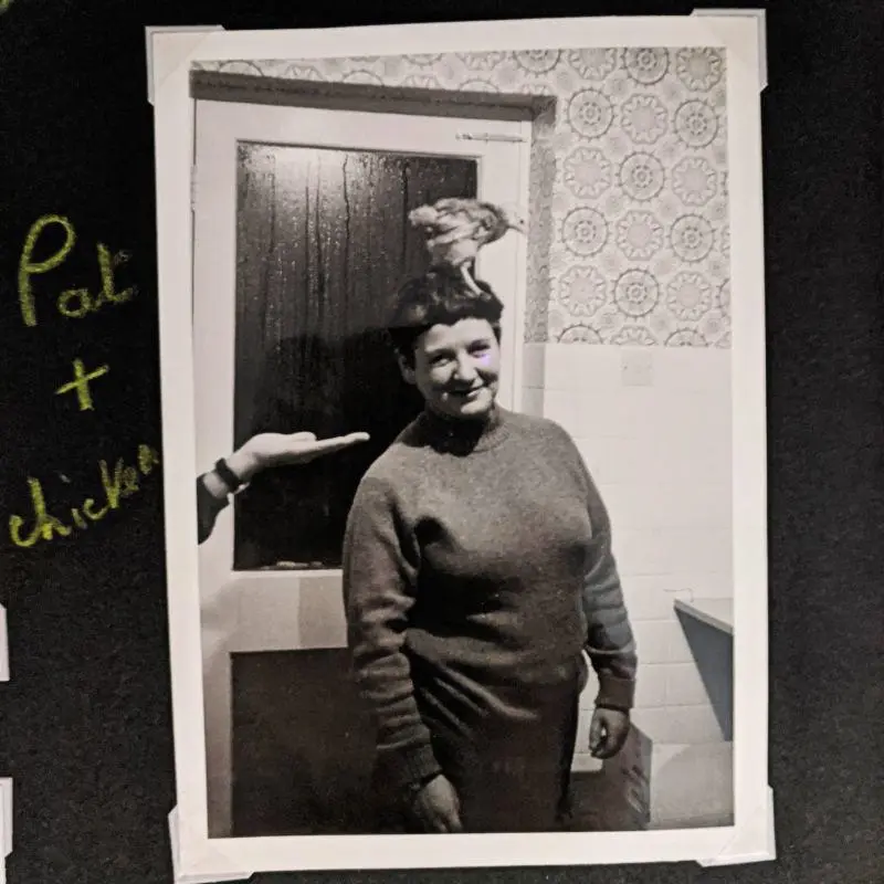 Pat Arrowsmith with a chicken on her head.