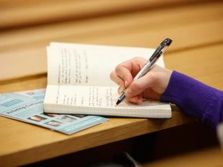A student writing in a notebook