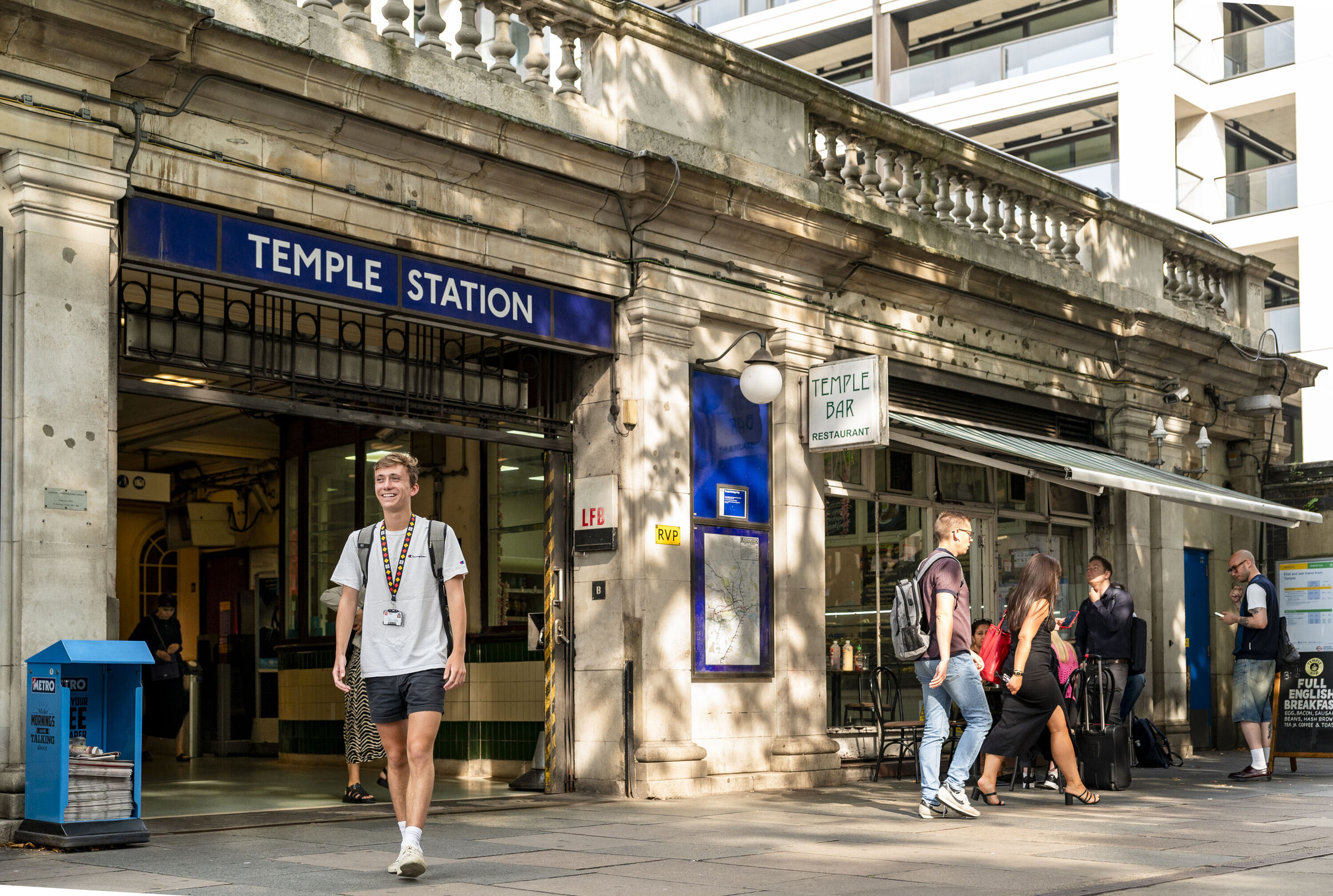 Commuter student walking out of Temple tube station towards LSE campus