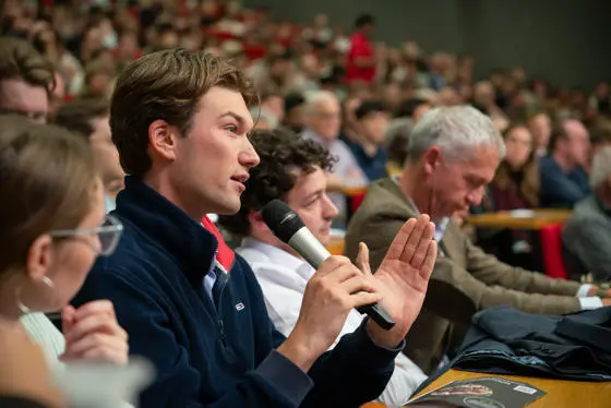 An audience member asking a question at a public lecture