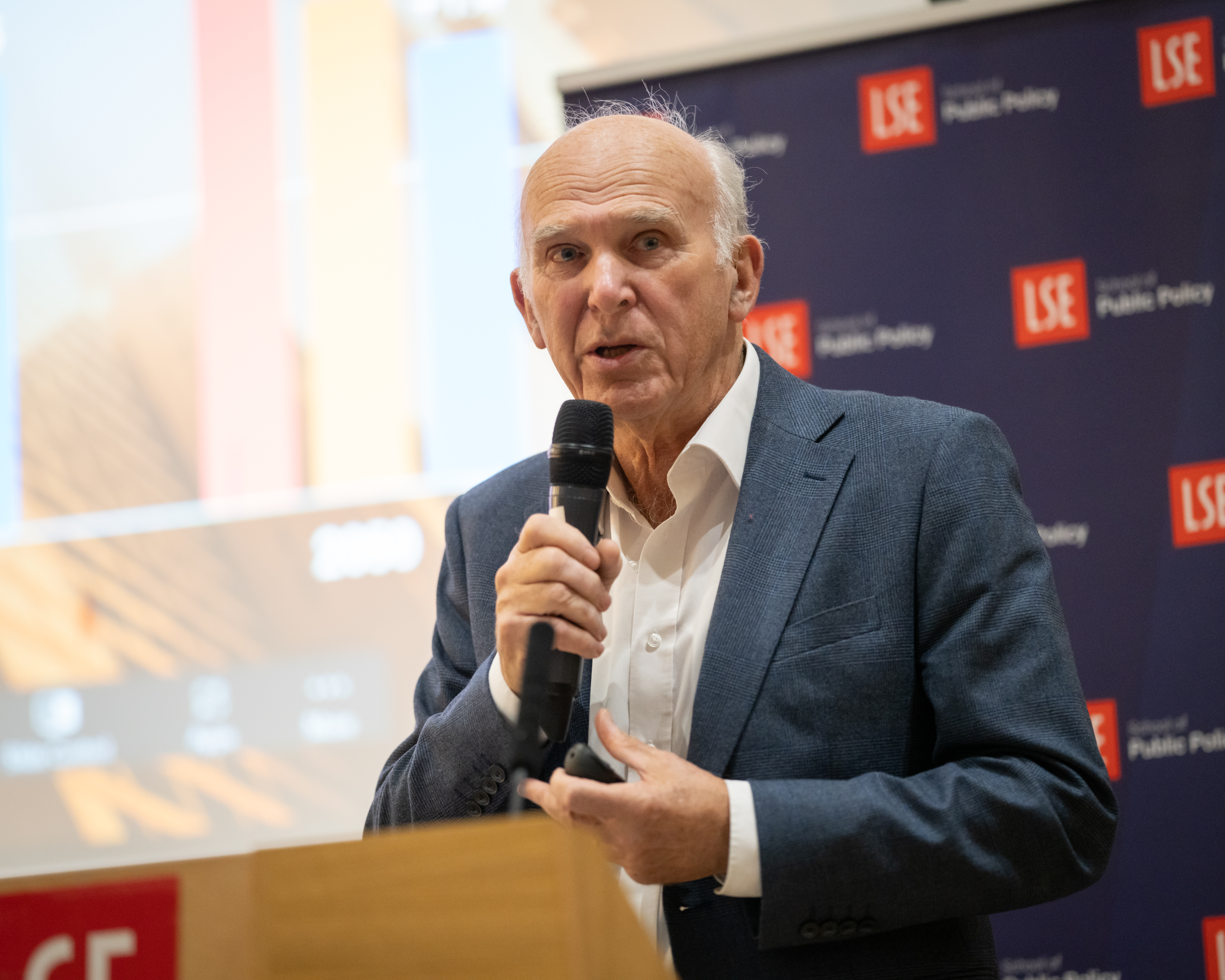Sir Vince Cable presenting at a public event