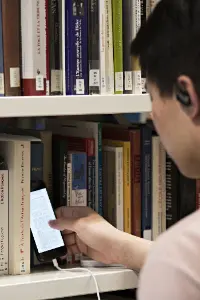 Student on their phone in the LSE Library