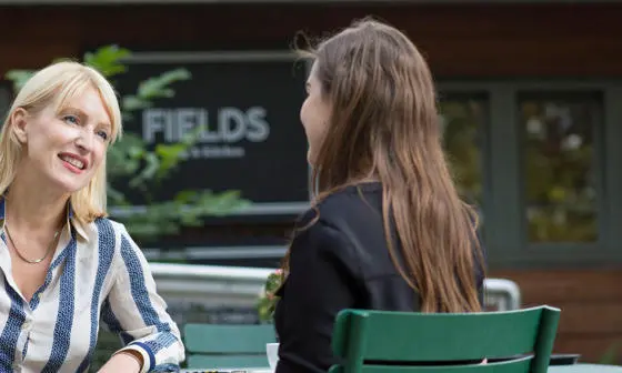 LSE Careers consultant chatting outside the Fields Kitchen near Lincoln Inn's Fields.