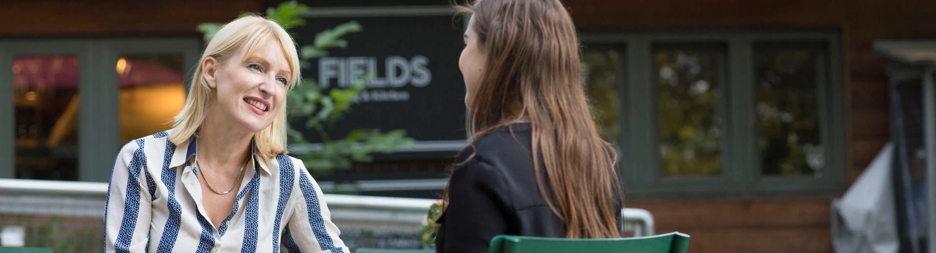 LSE Careers consultant chatting outside the Fields Kitchen near Lincoln Inn's Fields.