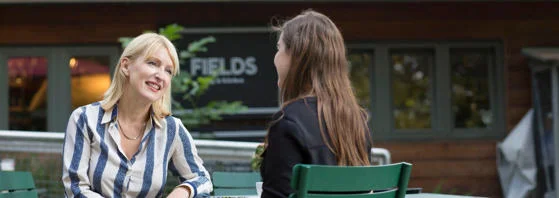 LSE Careers consultant chatting outside the Fields Kitchen near Lincoln Inn's Fields.