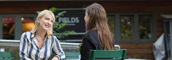 LSE Careers consultant chatting outside the Fields Kitchen near Lincoln Inn's Fields.
