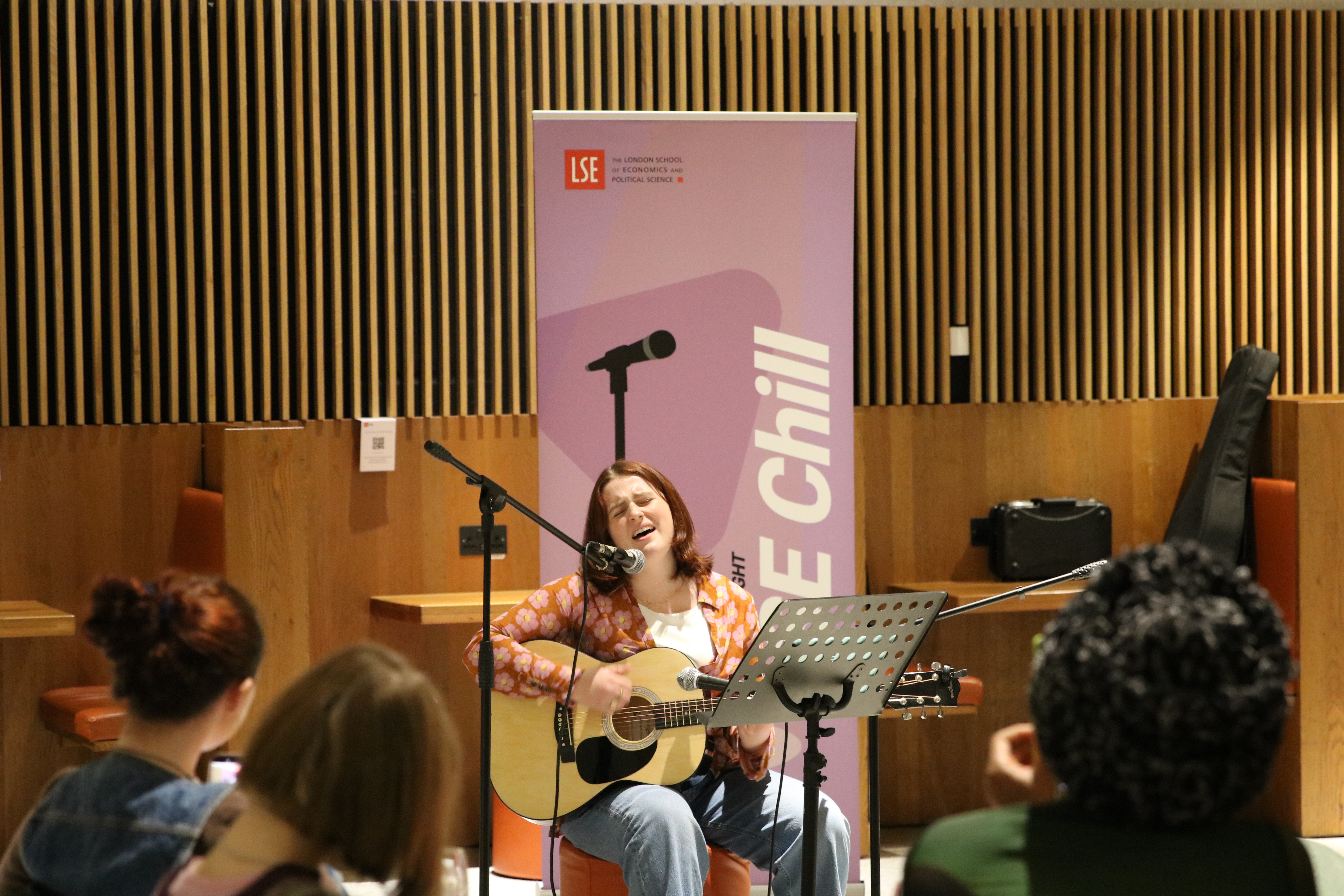 Student plays guitar and sings at LSE Chill