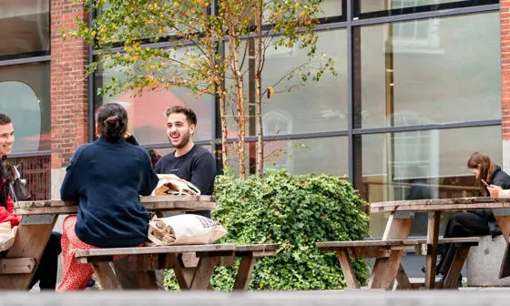 Students sitting outside the LSE Library.