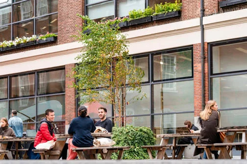 Students sitting outside the LSE Library