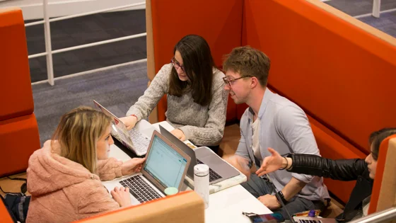 Four students working in a pod