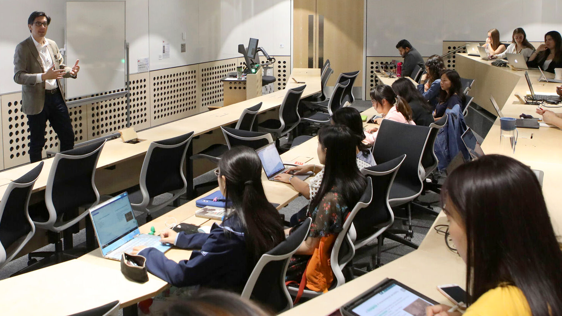 Students in class taking notes