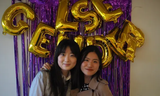 Two students smiling