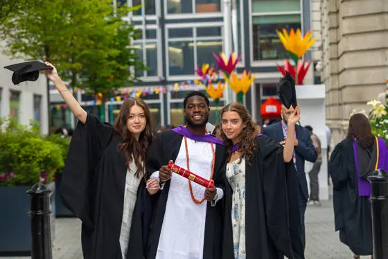 One male and two female LSE graduates.