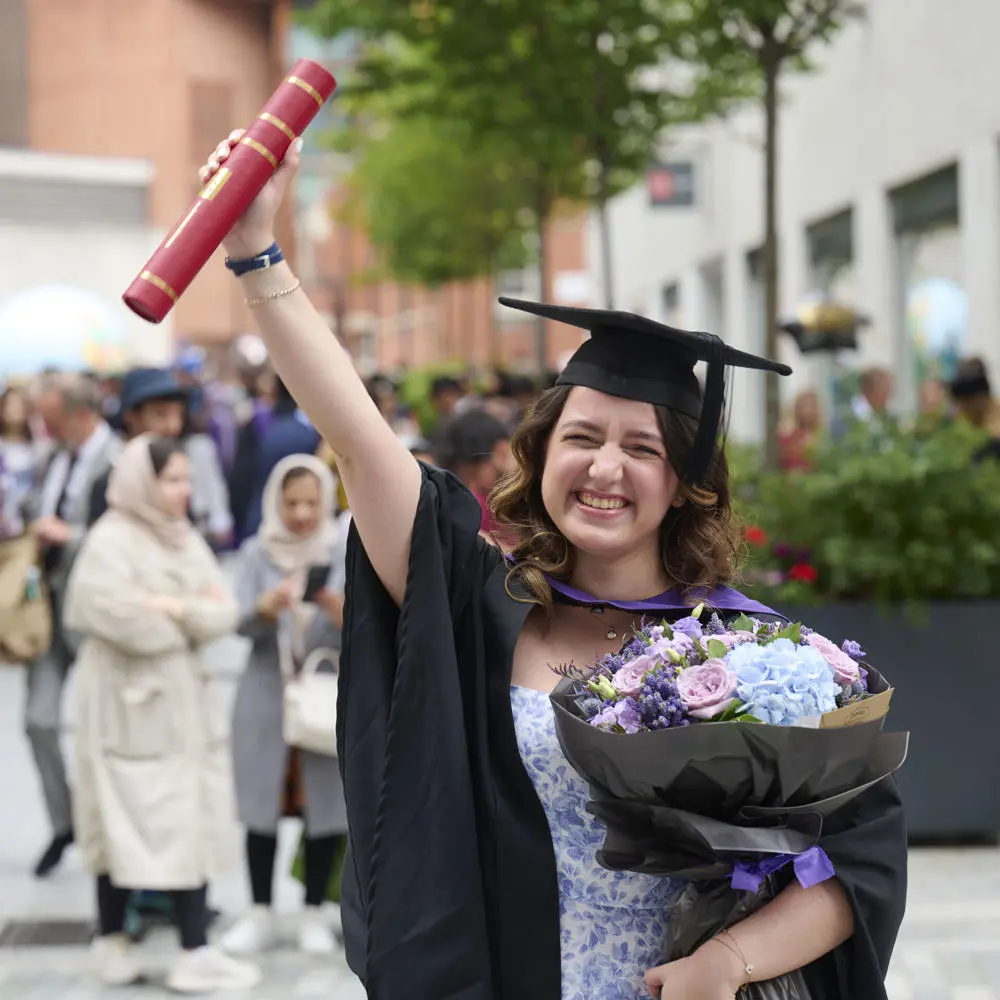 LSE graduate with flowers